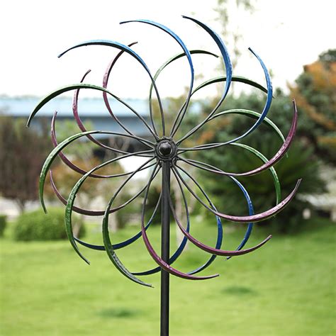 This metal spinner's pink, purple and blue sphere is split into two parts that move independently to create a hypnotic movement. Curved blades are set at an angle to bring even more dimension to this dynamic artwork. This large spinner is a fantastic focal point in any yard or garden. 4-Prong stake keeps this one firmly in place sturdy metal ... 